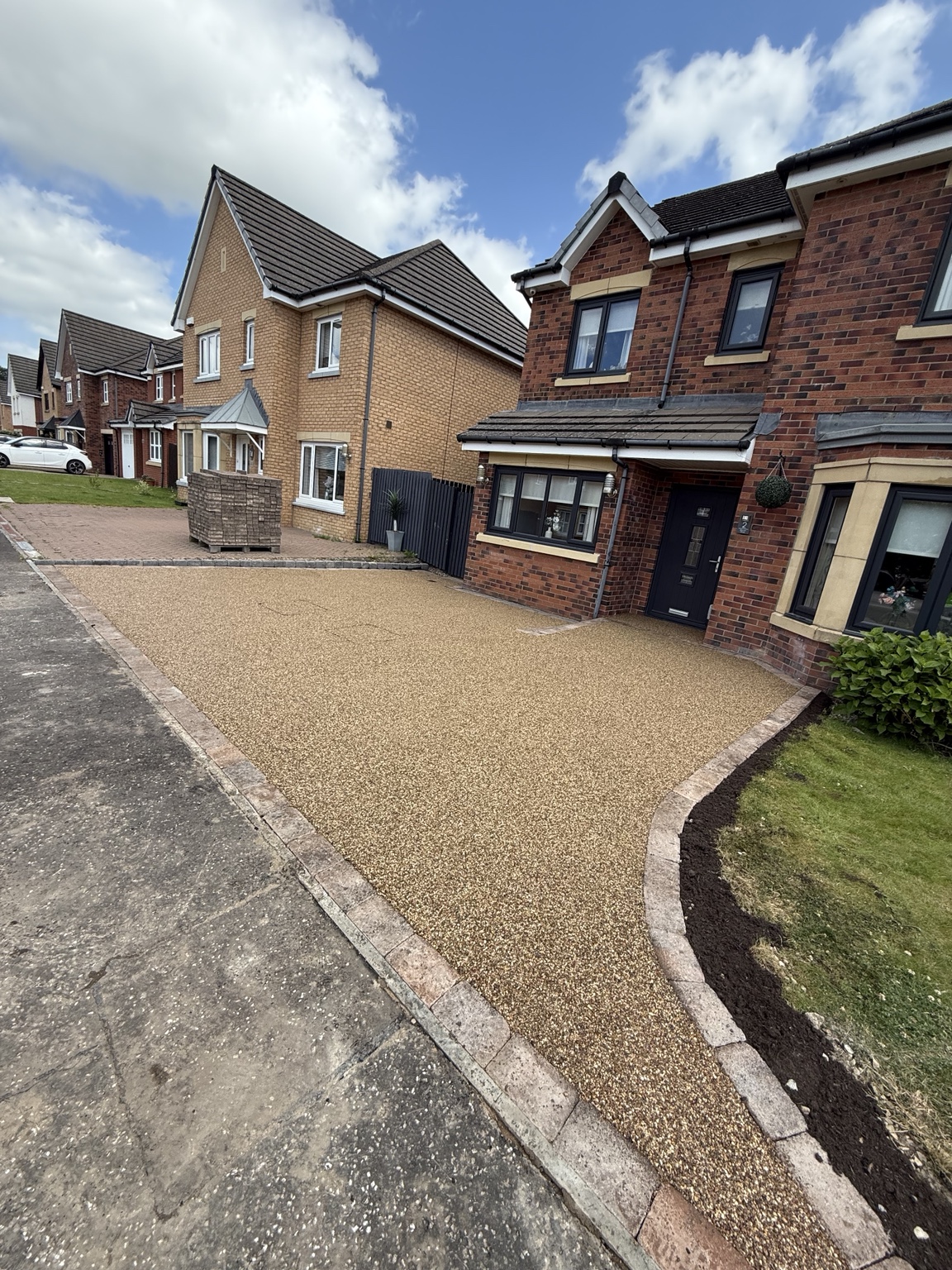 Golden resin-bound driveway with stone edging